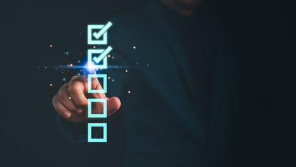 Businessman touching digital checklist interface with glowing checkboxes. Concept for online survey, task completion, project planning, and productivity management in digital work environments.
