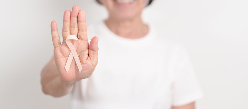 Elderly woman with Peach Ribbon for September Uterine Cancer Awareness month, Endometrial Cancer, Gynecologic, Uterus and Ovaries, Endometriosis, June Vaginal cancer and World cancer day concept