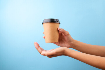 Female Hands Showing Coffee Cup Isolated On Blue Background