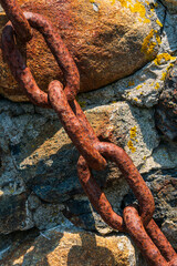 Rusted chain on rocks
