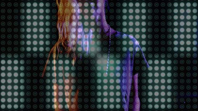 DJ woman pressing fader initiating LEDs pulsing for matching beat while adjusting headphones