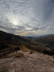 Scenic mountain landscape with a dramatic cloudy sky. View from a hiking trail on a dry, rocky...