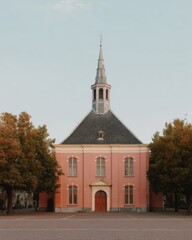 Fototapeta premium Authentic Dutch Reform Church with Tall Steeple on Religious History Day in Autumn Featuring Oktoberfest Festive Vibes for Premium Millennial Travel Marketing Content