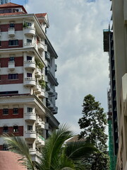Urban architecture contrast with an ornate red and white apartment building next to a modern...