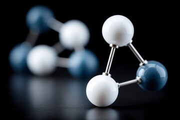 Molecular model with white and blue spheres and metallic rods on a reflective dark surface
