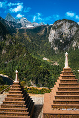 Tibetan Stupa with Prayer Flags and Snowy Peaks in Balagezong, Shangri-La, Yunnan.