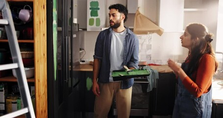 Home, argument and couple with renovation, discussion and disagreement in kitchen. People, apartment and man with woman, property interior or fighting with conversation, angry and conflict with paint - Powered by Adobe