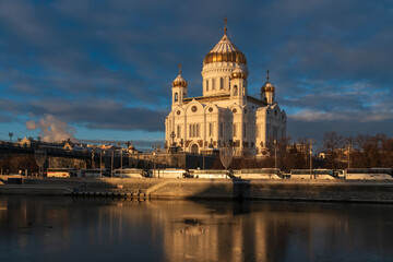 View of the Cathedral of Christ the Savior and the Patriarchal Bridge from the Beresnevskaya embankment of the Moskva River on a sunny winter day, Moscow, Russia