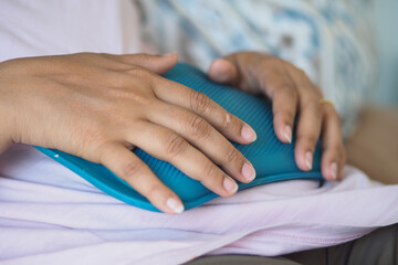 Using a heating pad for relief on a cozy sofa