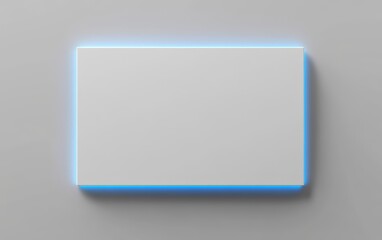 Empty white rectangle illuminated by blue light on gray wall