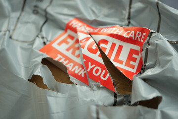 Delivery package showing damage with fragile notice