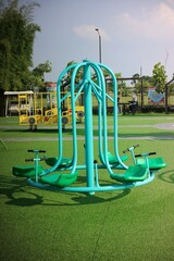 Playground Equipment Featuring Colorful Carousel Under Sunny Sky
