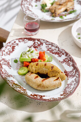 Grilled sausages with vegetable salad, bright daylight, overhead plate composition