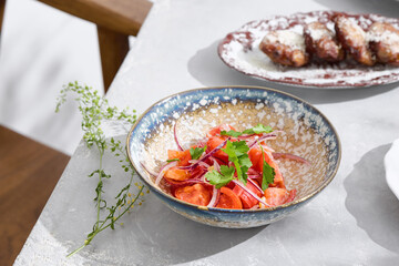 Tomato and red onion salad, bright natural lighting, overhead minimalist composition