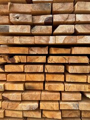 ends of the wooden pine edged planks in the warehouse close-up