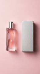 Elegant glass perfume bottle and silver box on a soft pink background