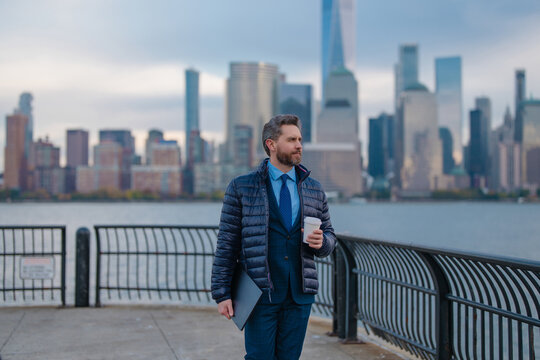 Businessman at business district in NYC. Portrait of business man in New York city. Success in America. Mature office worker in suit. outside. Take away coffee break in Manhattan. - Powered by Adobe