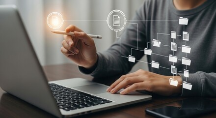 Person using laptop with digital file management interface overlayed on the screen display view