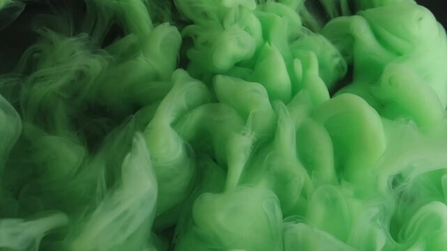 Fog fluid. Paint spread. Green haze puff stream curl splash spilling on black background. Defocused art abstract fantasy flow dye shot.
