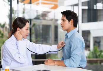 Asian doctor talk with patient about disease symptom, doctor use stethoscope listening lung of...