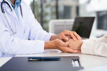 Doctor, patient and holding hands in a medical office. , empathy and support in depression, anxiety...