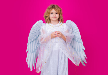 Valentines day. Kid with angel wings. Studio portrait of angel child on studio color isolated...