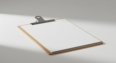 Clipboard with White Paper and Steel Clip on Light Gray Surface