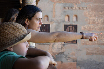 Mother pointing at something while sightseeing with children