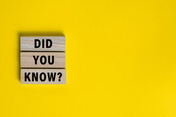 did you know words on wooden blocks isolated on yellow background. copy space