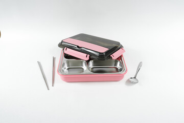 Plastic and stainless lunch box, which is black and pink in color. n white background, food...