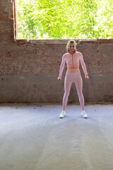 A strong and determined athlete confidently dressed in vibrant activewear stands out in an urban...