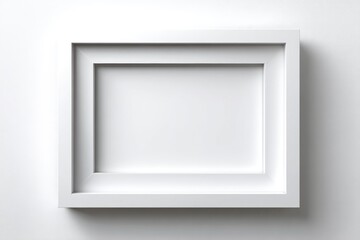 Fototapeta premium Empty white picture frame against a plain background.
