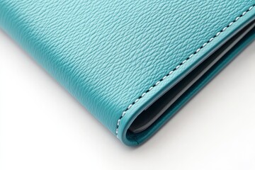 Close-up of teal leather wallet corner.