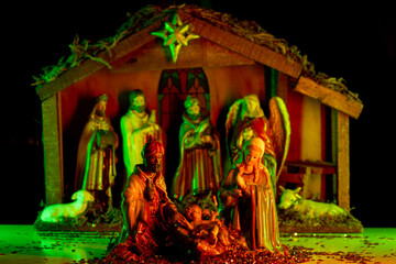 Christmas greeting card. Christmas Manger scene with figures of Jesus, Mary, Joseph, sheep and...