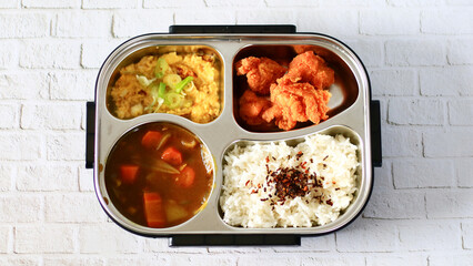 Bring packed lunch. Rice topped with nori, Japanese curry, karage and fried scrambled eggs.      