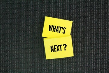 Colored paper with the word question What's Next? next step concept. coming immediately after the...