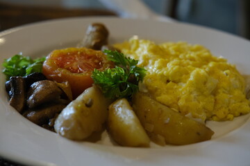 Breakfast Plate with Omelette, Sausages, Tomato, and Herbed Potatoes