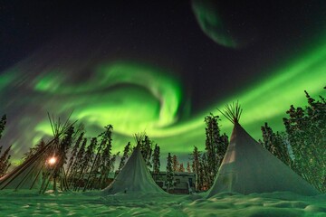 Northern Lights, Aurora Borealis over Teepee and Forest, Yellowknife, Northwest Territories, Canada © Seongpil Jang