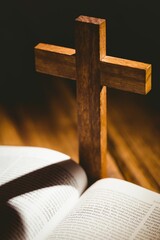 Shadow of wooden cross falling on bible