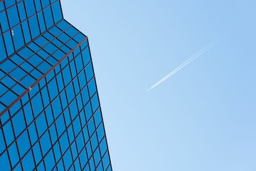 Low angle view of office building against blue sky