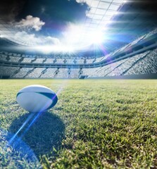 Football on field in stadium.