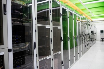 Long row of server cabinets is stretching along data center corridor in flat design with cables © vectorfusionart