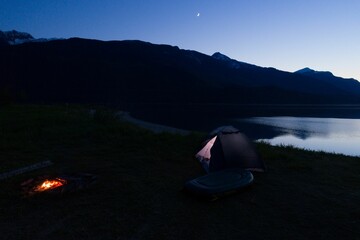 Tent standing beside lake in the evening