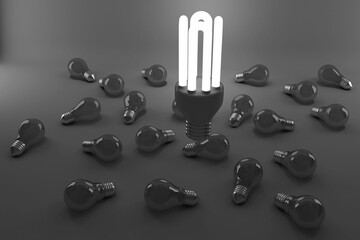 High angle view of lit energy efficient lightbulb over bulbs