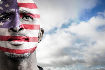 Man is gazing upward in vector portrait, featuring flag face paint beneath cloudy sky