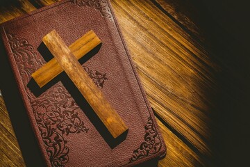 Close-up of wooden cross on bible