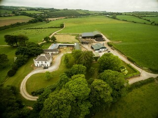 Aeriel view of house on green landscape