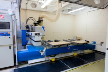 3D render showing blue CNC milling machine is working in workshop with dust hose, control console