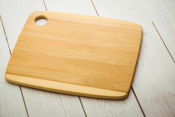 Chopping board on white wooden flooring