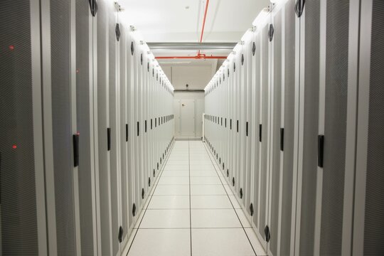 Showing flat design data center corridor with server cabinets, raised tiles, conduit, exit door